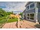 Backyard with a wooden deck, an artificial lawn, a stone decoration, and a wooden fence at 2295 Sandhurst Dr, Castle Rock, CO 80104