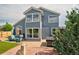 Backyard with deck, patio furniture, hot tub, and manicured lawn at 2295 Sandhurst Dr, Castle Rock, CO 80104