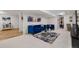 Finished basement space with blue couch, decor, and tv at 2295 Sandhurst Dr, Castle Rock, CO 80104