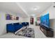 Finished basement with TV, blue couch, decor, lighting, and a glass table at 2295 Sandhurst Dr, Castle Rock, CO 80104
