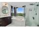 Bright, updated bathroom with walk in shower, stand alone tub, vanity, and natural light at 2295 Sandhurst Dr, Castle Rock, CO 80104
