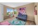 Bright bedroom space with large windows and furnished with a pull out couch and carpet at 2295 Sandhurst Dr, Castle Rock, CO 80104