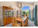 Elegant dining room with a large table, chandelier, and backyard view at 2295 Sandhurst Dr, Castle Rock, CO 80104