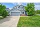 Charming two-story home featuring a well-maintained yard, gray siding, and an attached two-car garage at 2295 Sandhurst Dr, Castle Rock, CO 80104