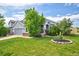 Lovely home with a well-kept lawn, gray siding, and a charming front yard garden at 2295 Sandhurst Dr, Castle Rock, CO 80104