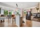 Spacious open-concept kitchen with stainless steel appliances and eat-in bar, leading into a well-lit dining room at 2295 Sandhurst Dr, Castle Rock, CO 80104