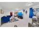 Spacious living room featuring stylish blue furnishings, modern lighting, and sleek entertainment setup at 2295 Sandhurst Dr, Castle Rock, CO 80104