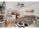 Open-concept living room area featuring a sofa set, fireplace, and an eat-in kitchen bar with modern pendant lighting at 2295 Sandhurst Dr, Castle Rock, CO 80104
