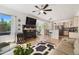 Open-concept space with living room and breakfast nook with bar seating, fireplace, and view of the kitchen with appliances at 2295 Sandhurst Dr, Castle Rock, CO 80104