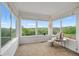 Bright sun room with large windows, a chair, and views of the surrounding landscape at 2295 Sandhurst Dr, Castle Rock, CO 80104