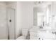 Bright bathroom with a white vanity, framed mirror, and glass-enclosed shower at 5840 Longs Peak St, Brighton, CO 80601