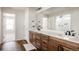 Spacious bathroom with double vanity, wooden cabinets, and a separate shower and bathtub at 5840 Longs Peak St, Brighton, CO 80601