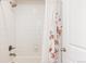 Clean bathroom featuring white subway tile in the shower and neutral accents at 5840 Longs Peak St, Brighton, CO 80601