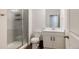 Bright bathroom featuring a glass shower, white vanity and toilet at 5840 Longs Peak St, Brighton, CO 80601