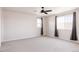 Spacious bedroom with neutral paint, plush carpet, and lots of natural light at 5840 Longs Peak St, Brighton, CO 80601
