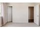 Bright bedroom featuring neutral walls, carpet, and access to two doors at 5840 Longs Peak St, Brighton, CO 80601