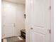 Entryway with storage bench, coat rack, wood look floors and white doors and trim at 5840 Longs Peak St, Brighton, CO 80601