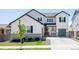Charming two-story home with a well-manicured lawn and gray accents at 5840 Longs Peak St, Brighton, CO 80601