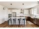 Modern kitchen boasts stainless steel appliances, a large island with seating, and stylish pendant lighting at 5840 Longs Peak St, Brighton, CO 80601