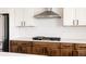Updated kitchen featuring white subway tile backsplash, modern appliances, white upper cabinets and stained lower cabinets at 5840 Longs Peak St, Brighton, CO 80601