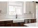 Well-lit kitchen featuring white subway tile backsplash, stainless steel appliances, and a farmhouse sink at 5840 Longs Peak St, Brighton, CO 80601