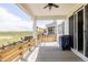 Covered patio featuring a gas grill and views of the surrounding landscape at 5840 Longs Peak St, Brighton, CO 80601