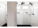 Modern shower featuring white subway tile, black fixtures, and a built-in shower niche at 5840 Longs Peak St, Brighton, CO 80601