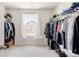 Walk-in closet with a window, built in shelving, and hanging racks at 5840 Longs Peak St, Brighton, CO 80601