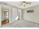 Bright bedroom with ceiling fan and view to hallway at 1059 Racine St, Aurora, CO 80011