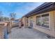 Brick front porch with wrought iron railings and a mature tree at 1059 Racine St, Aurora, CO 80011