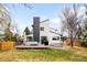 Modern home featuring a spacious backyard, a large deck with a grill and hot tub and an architectural chimney at 4362 Peach Ct, Boulder, CO 80301
