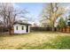 Large backyard with a storage shed, mature trees, and a well-maintained lawn, ideal for outdoor activities at 4362 Peach Ct, Boulder, CO 80301