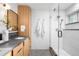 Modern bathroom featuring wooden cabinets, gray countertops, and a sleek glass shower at 4362 Peach Ct, Boulder, CO 80301