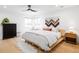 Bright bedroom featuring a modern bed, hardwood floors, and decorative wall hanging at 4362 Peach Ct, Boulder, CO 80301