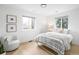 Bright bedroom with white walls, light wood floors, and natural light from two windows at 4362 Peach Ct, Boulder, CO 80301