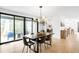 Open dining room with a modern chandelier, black table, and sliding doors overlooking the outdoor space at 4362 Peach Ct, Boulder, CO 80301