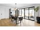 Light-filled dining area with a modern light fixture and sliding doors to an outdoor sitting area at 4362 Peach Ct, Boulder, CO 80301