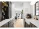 Modern kitchen featuring dark cabinets, marble countertops, stainless steel appliances, and light wood flooring at 4362 Peach Ct, Boulder, CO 80301