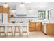 Bright kitchen featuring modern appliances, a white subway tile backsplash, and wood cabinetry at 4362 Peach Ct, Boulder, CO 80301