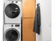 Convenient laundry area with modern stacked washer and dryer and functional storage at 4362 Peach Ct, Boulder, CO 80301
