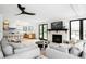 Open-concept living room and kitchen with a fireplace, a ceiling fan and two sofas at 4362 Peach Ct, Boulder, CO 80301