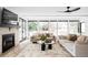 Spacious living room with a stone fireplace, large windows, and two sofas at 4362 Peach Ct, Boulder, CO 80301