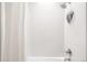 White tiled shower with chrome fixtures and bright light at 4362 Peach Ct, Boulder, CO 80301