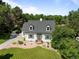 Aerial view of the charming home showcasing its manicured lawn, mature trees, and serene surroundings at 1033 Estes St, Lakewood, CO 80215