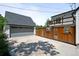 Backyard with a two-car garage, wood fence, and private balcony at 1033 Estes St, Lakewood, CO 80215