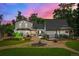 Lush backyard with manicured garden beds, covered patio, and cozy outdoor seating at 1033 Estes St, Lakewood, CO 80215