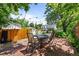 Cozy backyard patio with brick paving, string lights, and outdoor dining set at 1033 Estes St, Lakewood, CO 80215