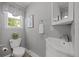 Bathroom showcasing a toilet, sink with vanity, and decorative mirror at 1033 Estes St, Lakewood, CO 80215