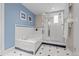 Stylish bathroom with a soaking tub, glass shower, and classic tile design at 1033 Estes St, Lakewood, CO 80215