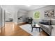 Bright room with wood floors, a desk, built-in shelving and a view into the primary bedroom at 1033 Estes St, Lakewood, CO 80215